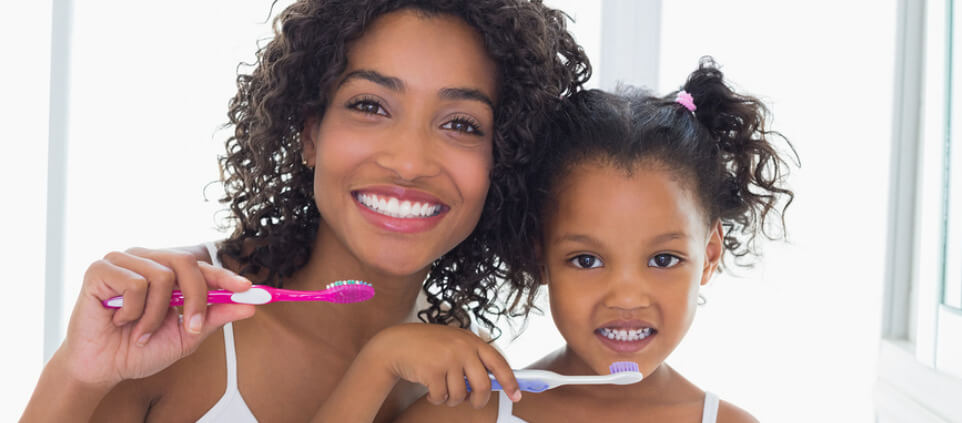 mother-and-daughter-brushing-teeth